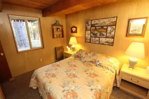 floral queen bed bedspread, beamed ceilings