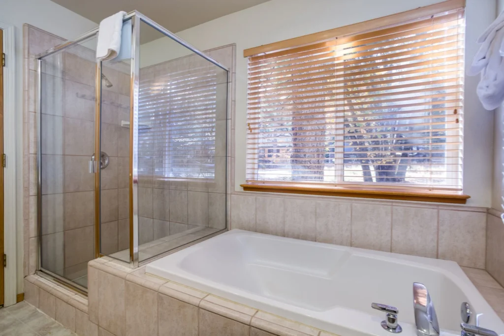 bathroom with shower and spa tub