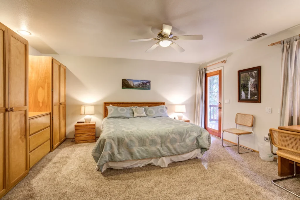 bedroom with large bed and wardrobe wall