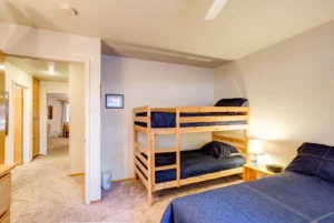 bedroom with full bed and bunk beds