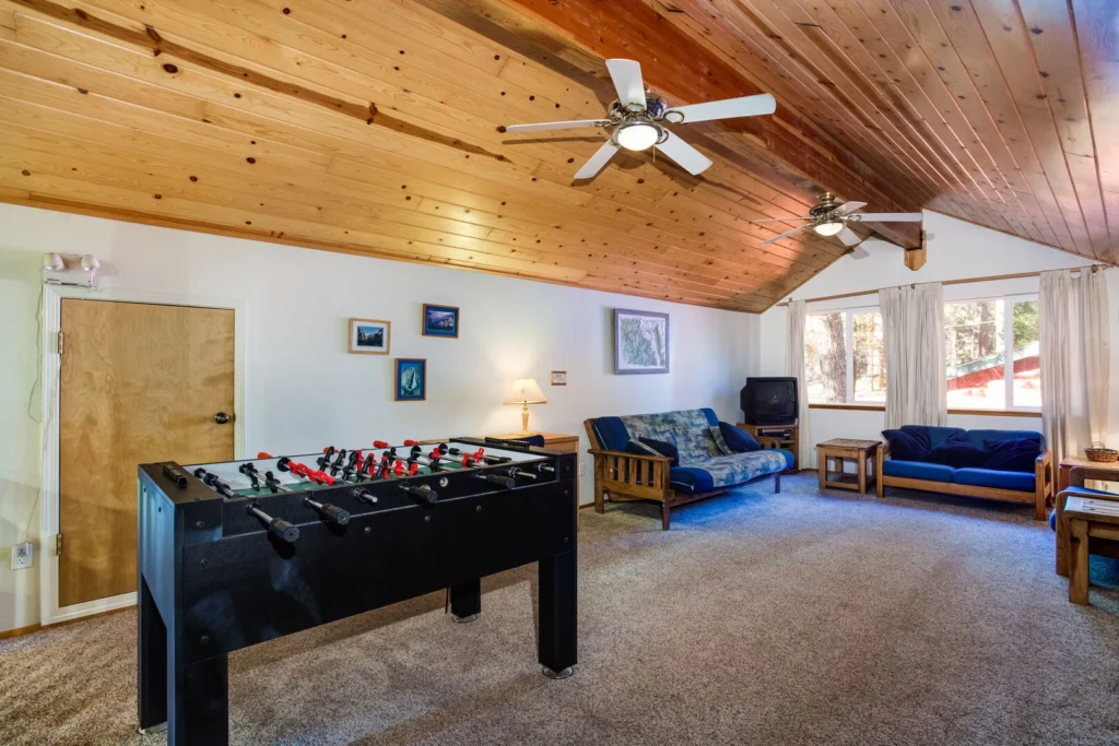 loft game room with foosball table and futon