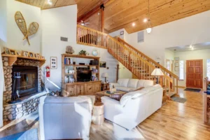 living room with stone fireplace and couches