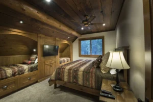 bedroom with large bed and two built in twin beds