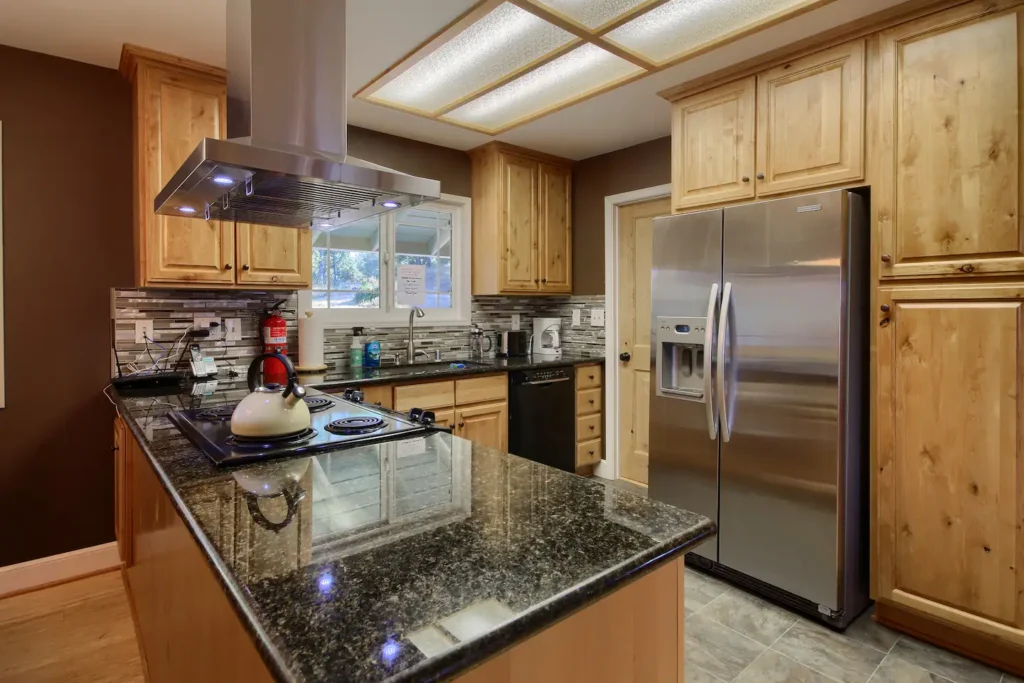 kitchen with black countertops and wood cabinets