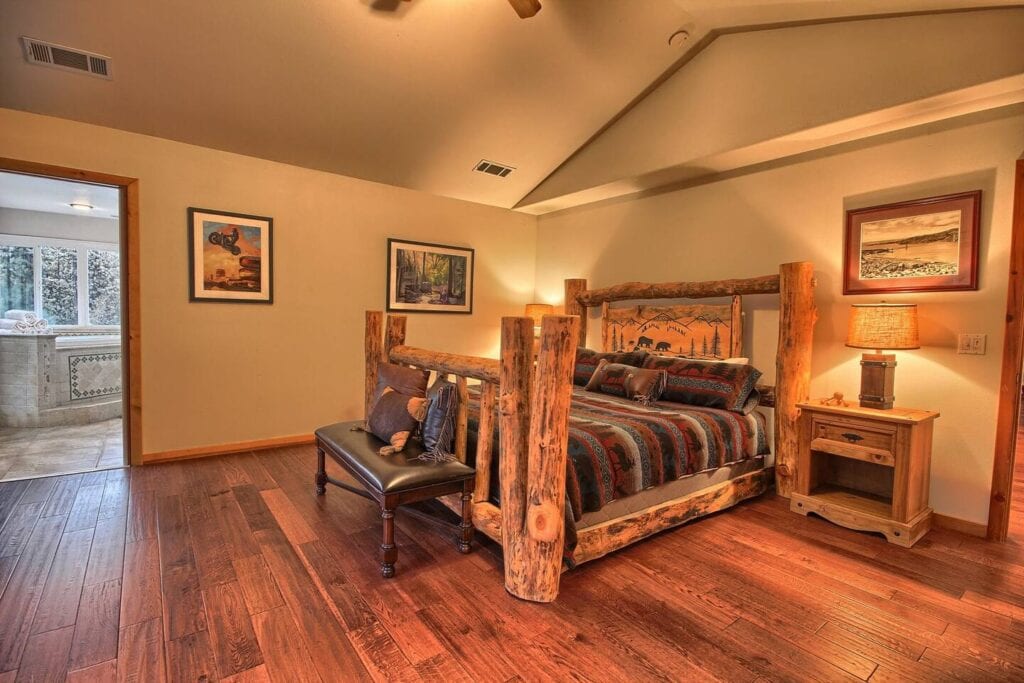 primary bedroom with wood carved bedframe