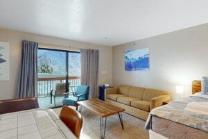 living area with couch leading out to balcony