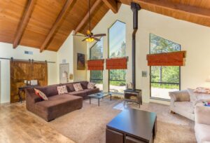 living area with wood stove, vaulted ceiling and seating