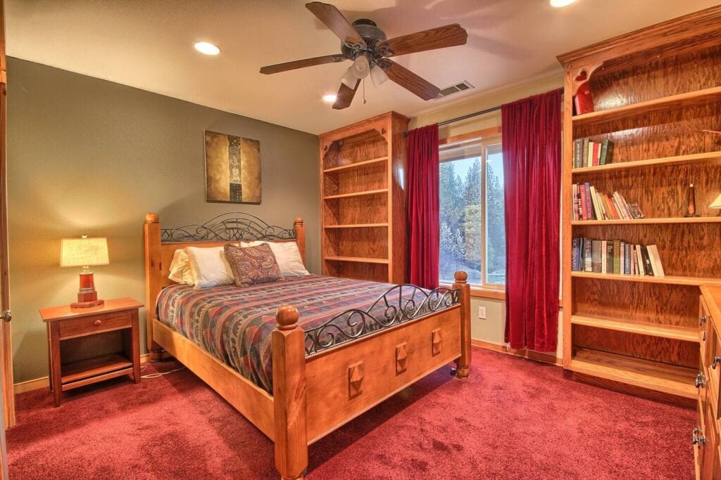 bedroom with queen bed and wood shelving