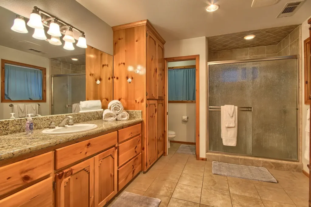 bathroom with large vanity and shower
