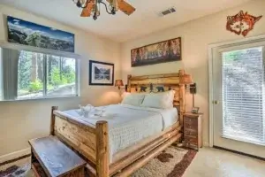 one bedroom with a queen size bed with a hand carved timber bed frame