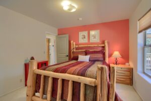 bedroom with queen bed with wood carved bed frame