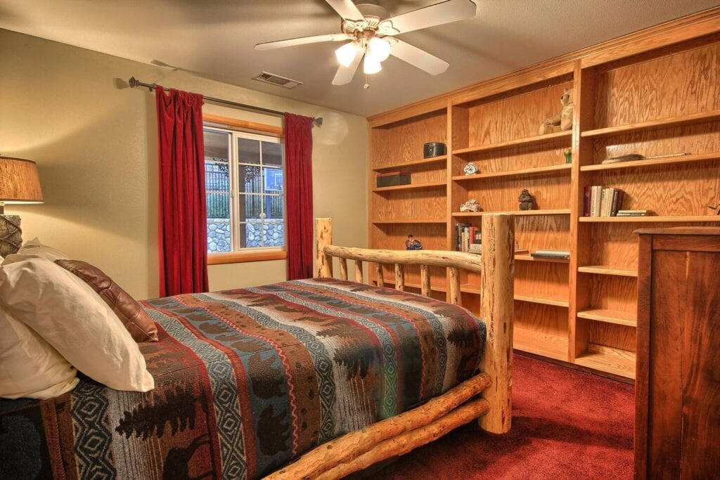 bedroom with queen bed and shelves