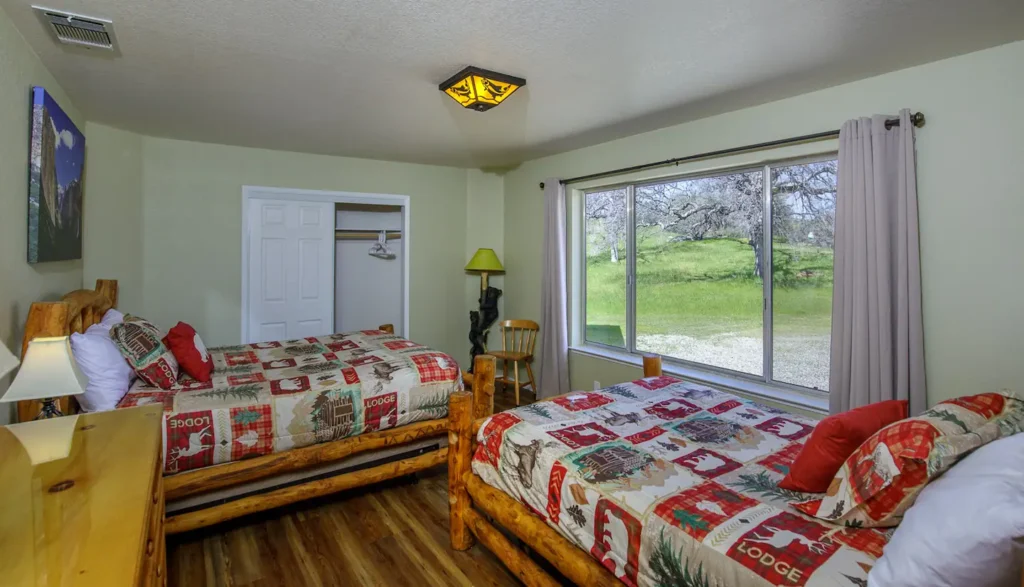 bedroom with carved wood queen and full beds