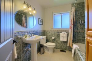 bathroom with shower tub and pedestal sink