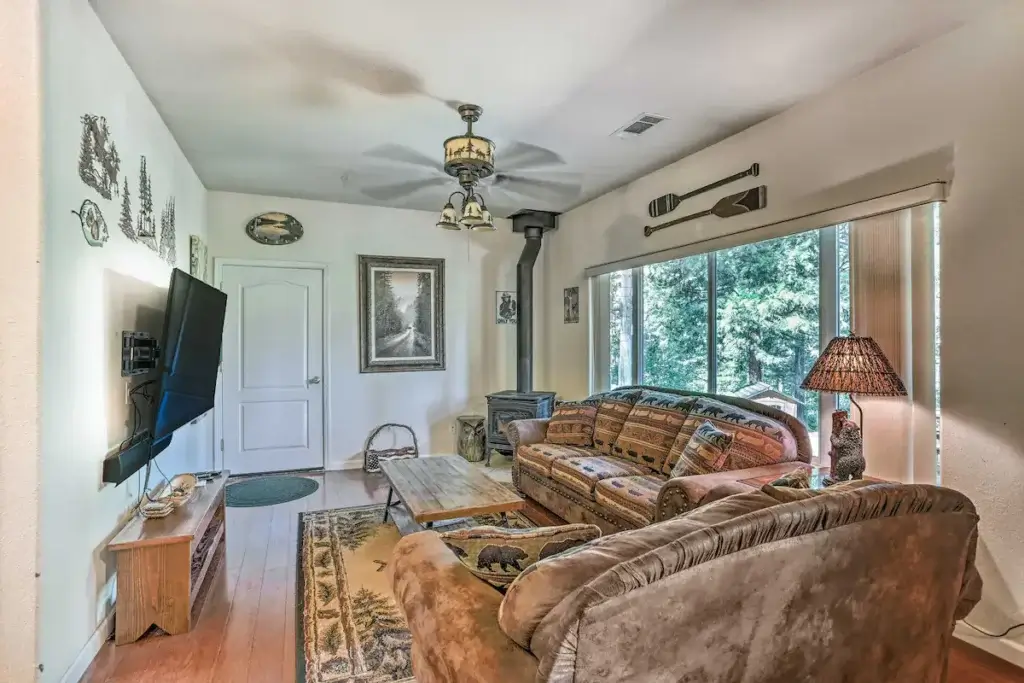 living room with cozy couches and a wood stove