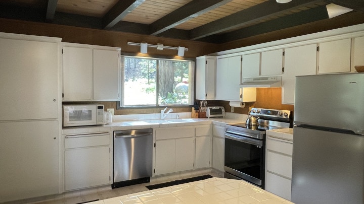 kitchen with beams and white cabinets