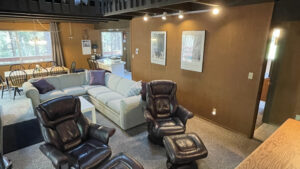 living room with couch and leather chairs