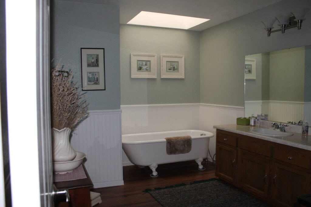 bathroom with tub and skylight