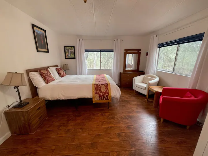 bedroom with windows and seating area