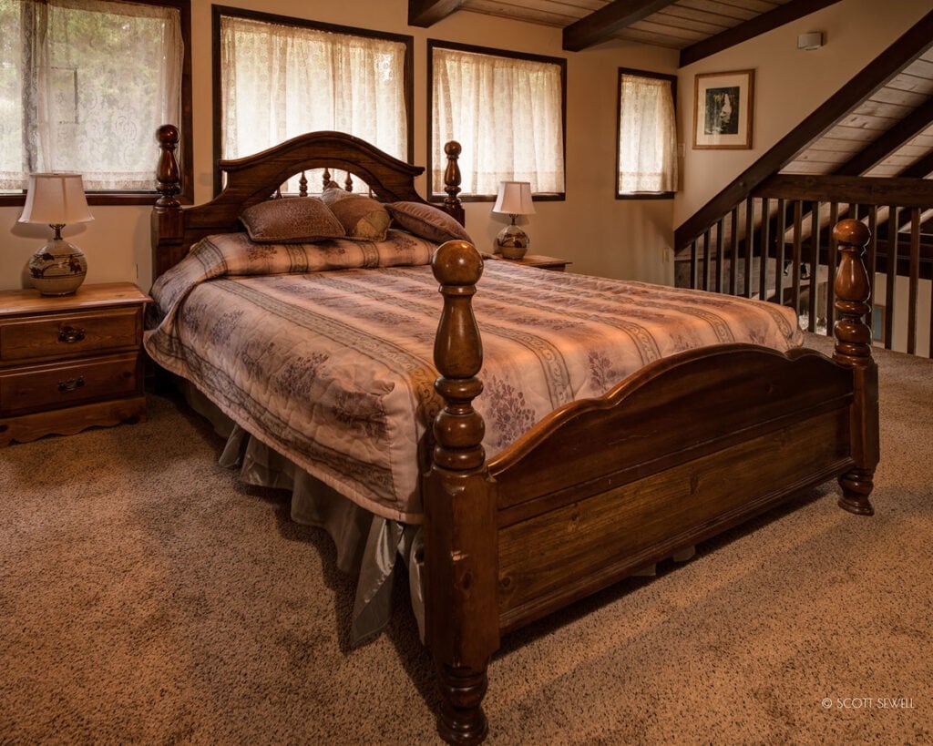 loft bedroom with ornate bedframe