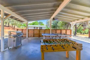 outdoor game room with pong pong table, foosball table and grill