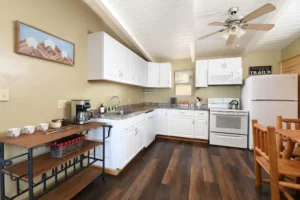 kitchen area with white cabinets and coffee bar
