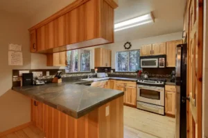 kitchen with wood cabinets, dark countertops, and peninsula island