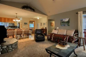 living room with couches, wood stove and view into dining room