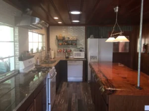 kitchen with wood slab island and white appliances