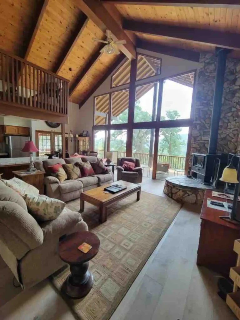 living room with vaulted ceilings, wood stove and seating