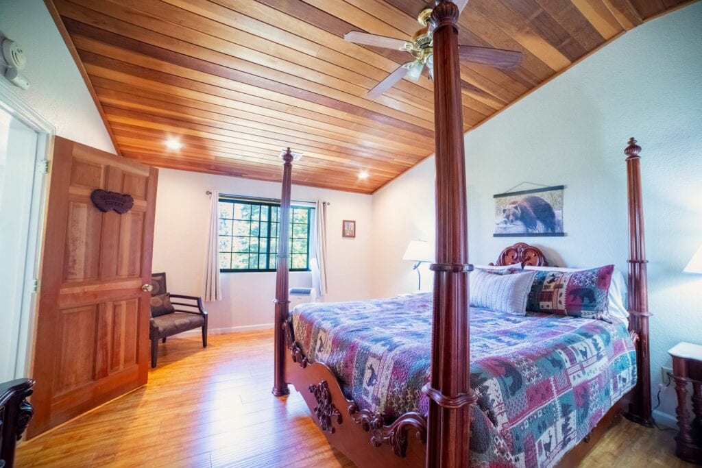 bedroom with four poster bed and chair