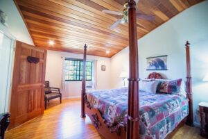 bedroom with four poster bed and chair