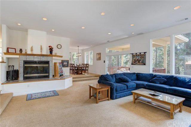 living room with blue sectional couch and fireplace