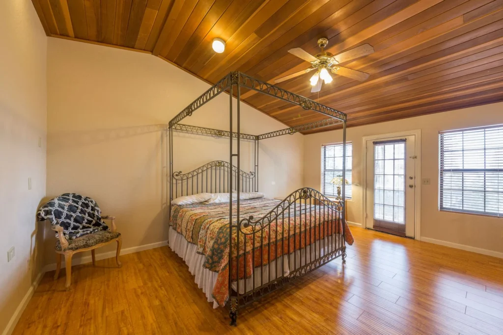 bedroom with wood paneled ceiling and canopy bed