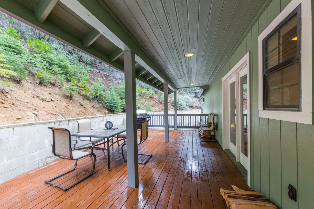 covered deck with outdoor seating and dining