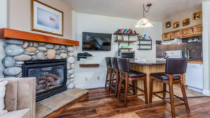 dining area and fireplace with television