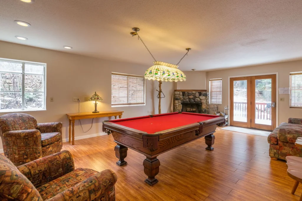 pool table and stone fireplace