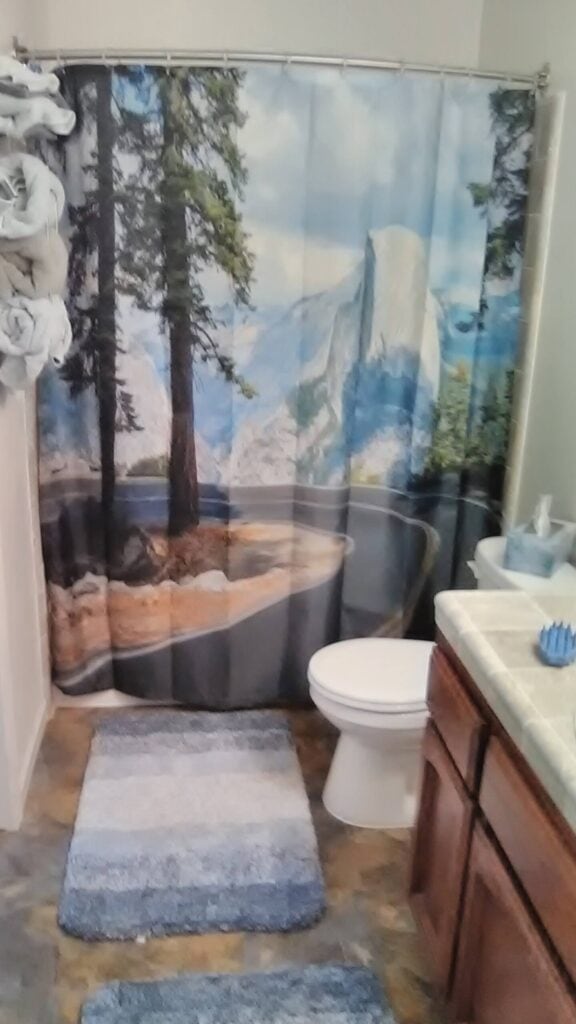 bathroom with shower and vanity