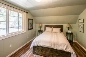 bedroom with queen bed and window