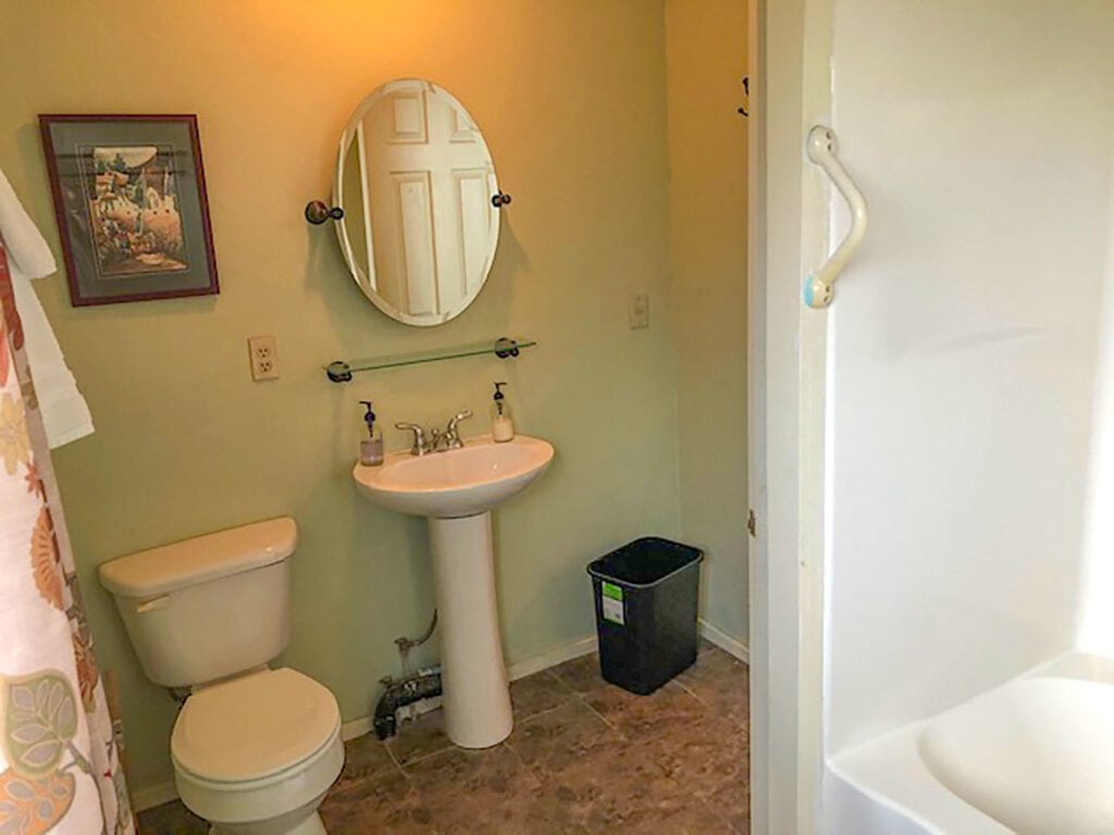 bathroom with shower and pedestal sink