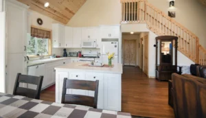 kitchen with tall ceiling and white cabinets