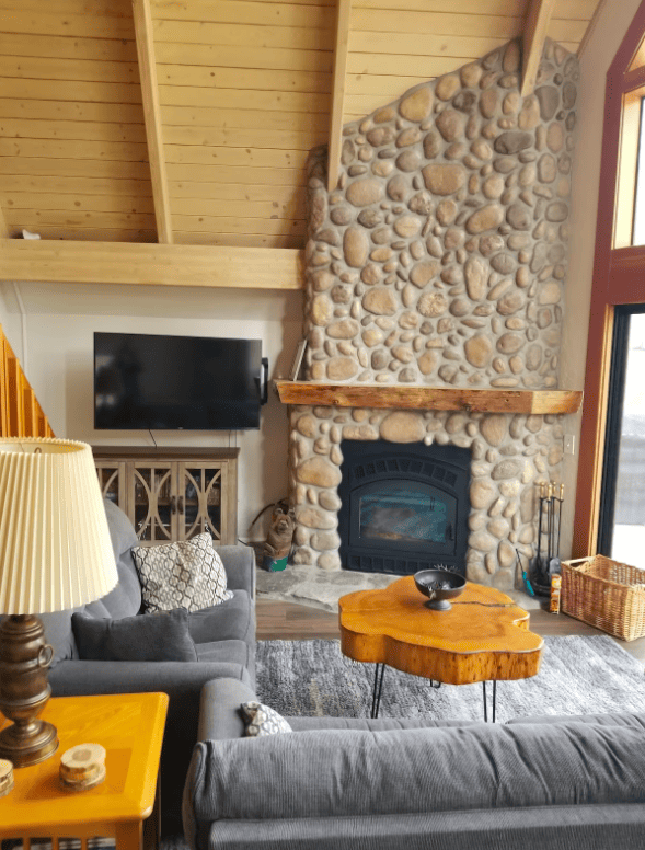 living room stone fireplace and television