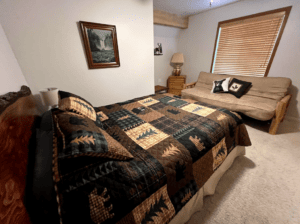 bedroom with queen bed and futon