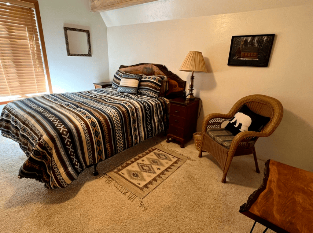 bedroom with queen bed and chair