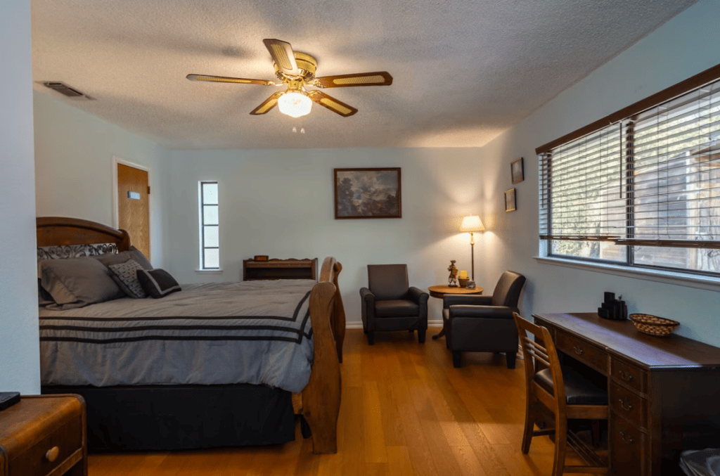 bedroom with queen sized bed and seating area