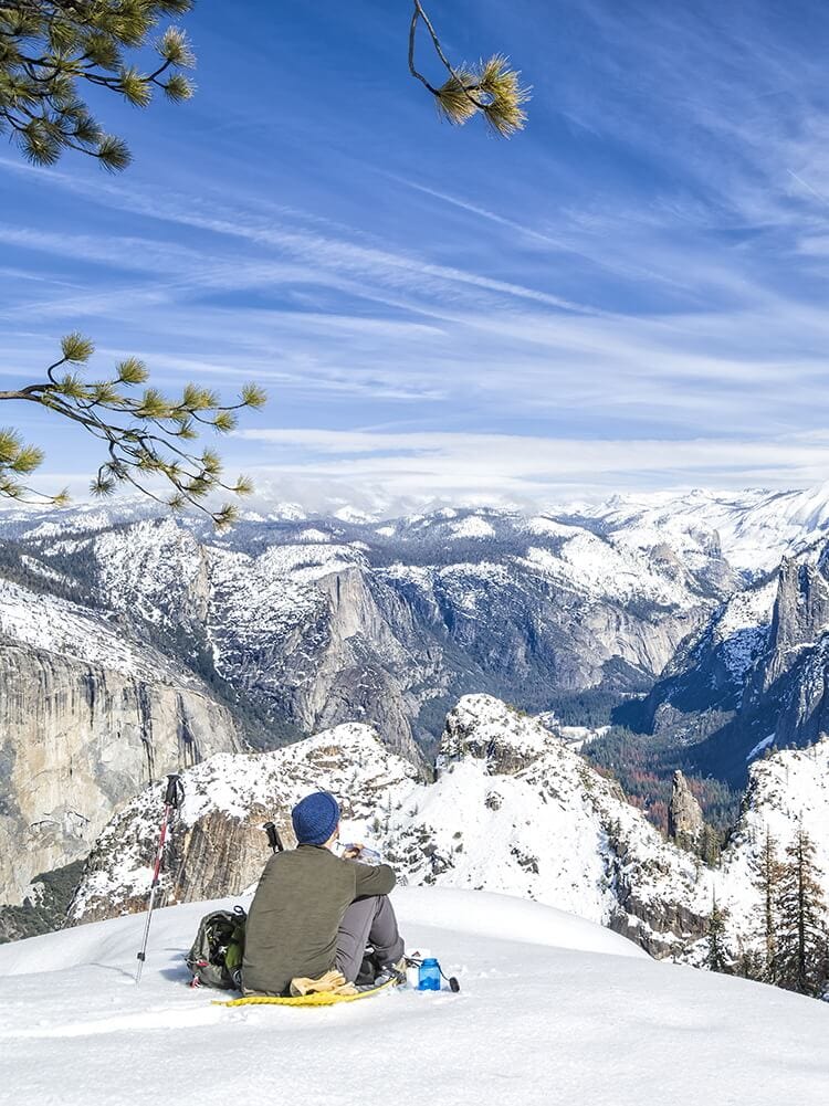 Snowshoer at Dewey Point enjoying the view