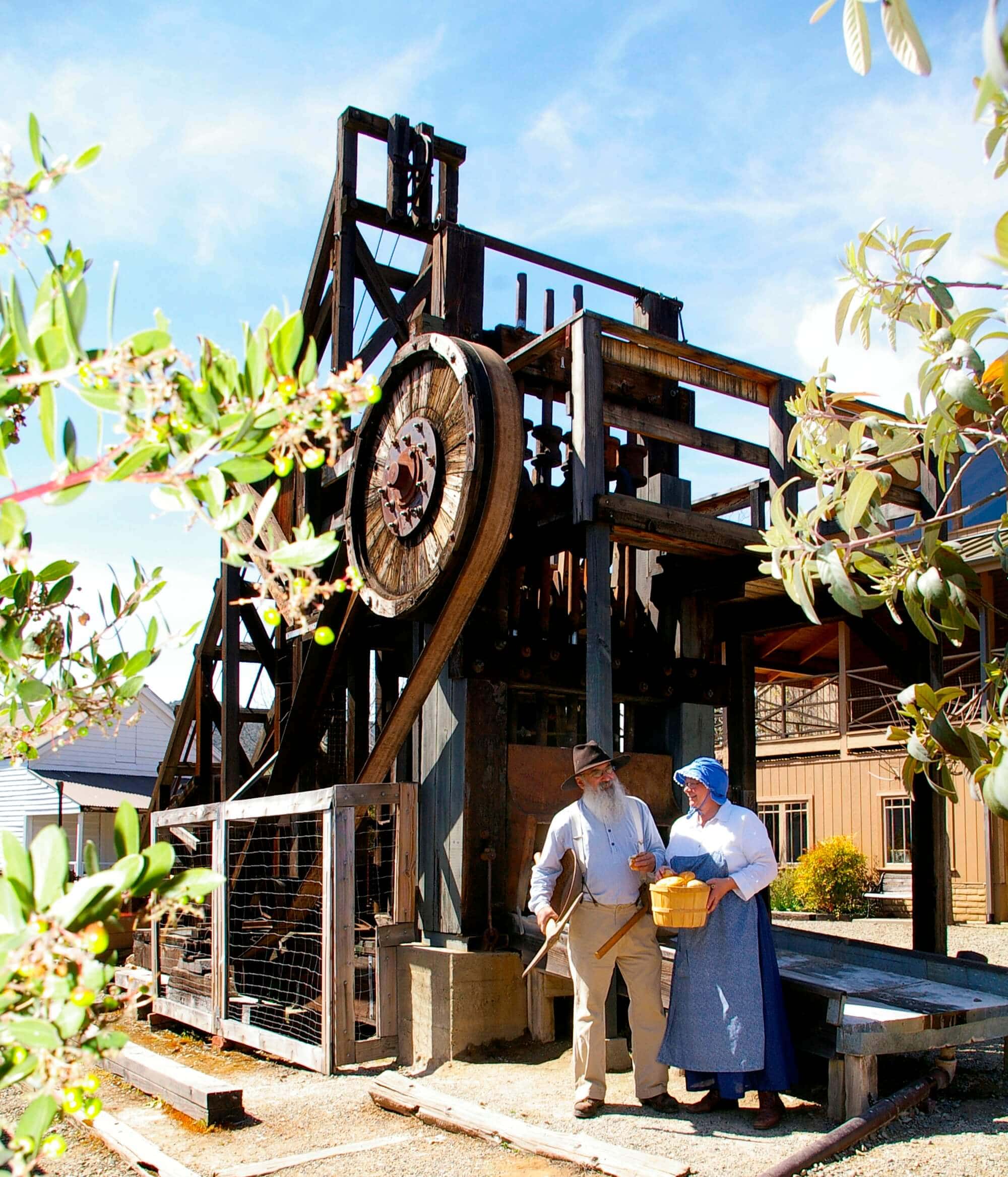 Man and woman in front of the working stamp mill