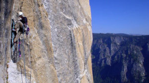 Aid Climbing on The Salathe Wall on El Capitan. You can see the webbing ladders called aiders or etriers used to make upward progress.