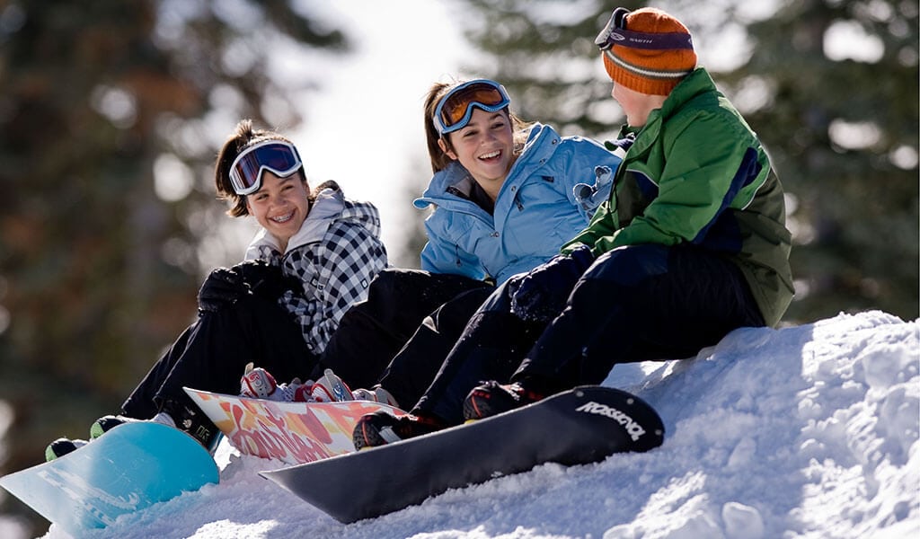 3 snowboarders chatting at Badger Pass in Yosemite