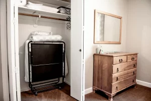 closet with foldable cot